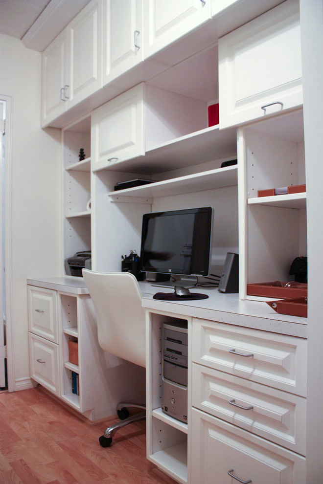 Inspiration for a small transitional study room in Calgary with white walls, no fireplace and a built-in desk.