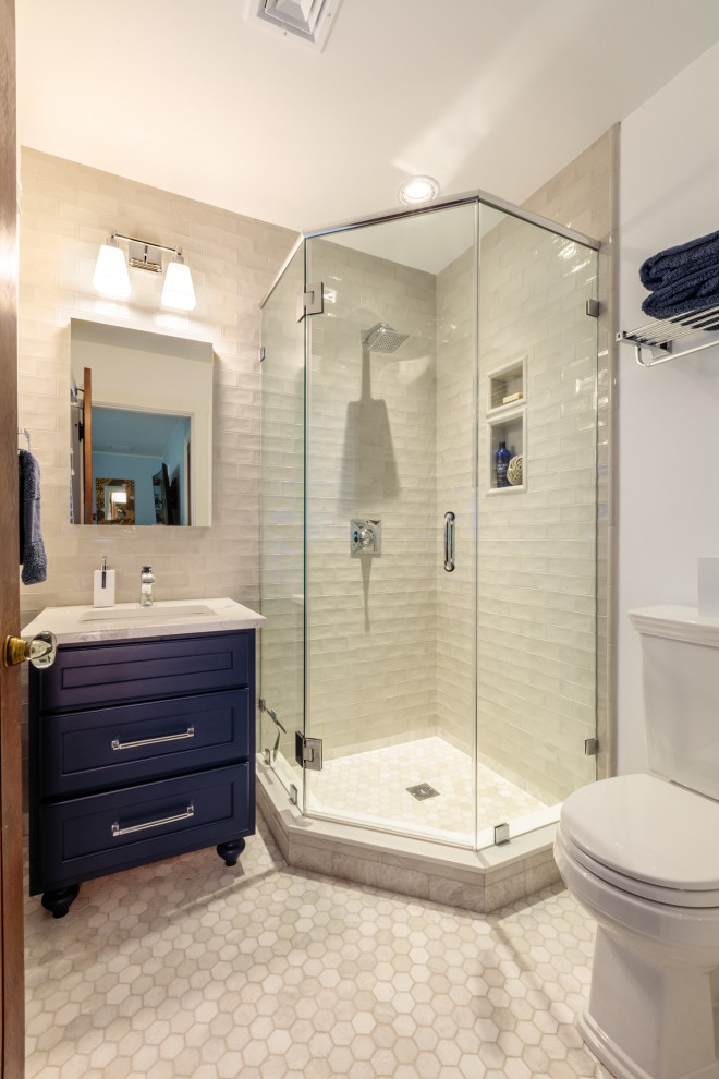 Photo of a small traditional shower room bathroom in Boston with shaker cabinets, blue cabinets, a corner shower, a two-piece toilet, grey tiles, porcelain tiles, marble flooring, a submerged sink, engineered stone worktops, grey floors, a hinged door, white worktops, a single sink and a freestanding vanity unit.