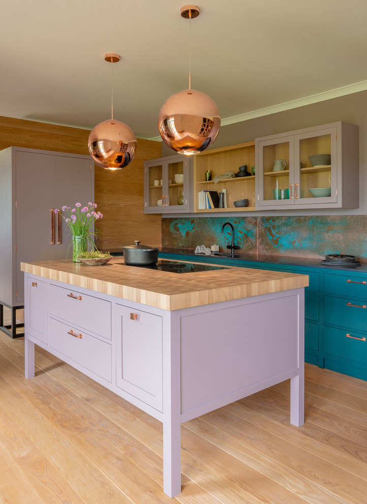 Mid-sized transitional galley kitchen in Other with shaker cabinets, purple cabinets, wood benchtops, blue splashback, light hardwood floors, with island, beige floor and beige benchtop.
