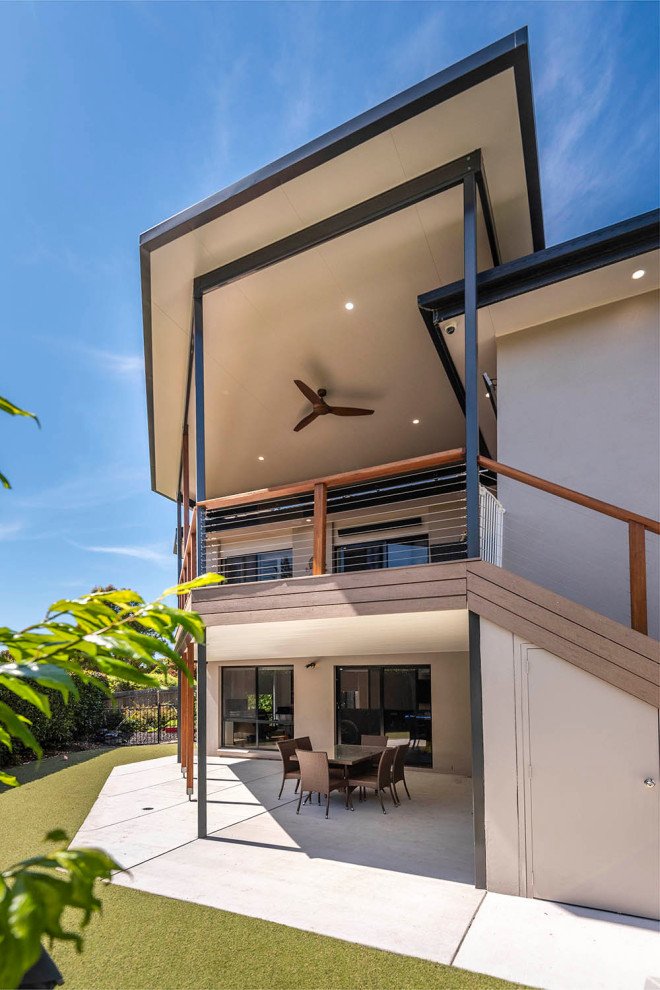 Inspiration for a large contemporary backyard deck in Canberra - Queanbeyan with a pergola and cable railing.