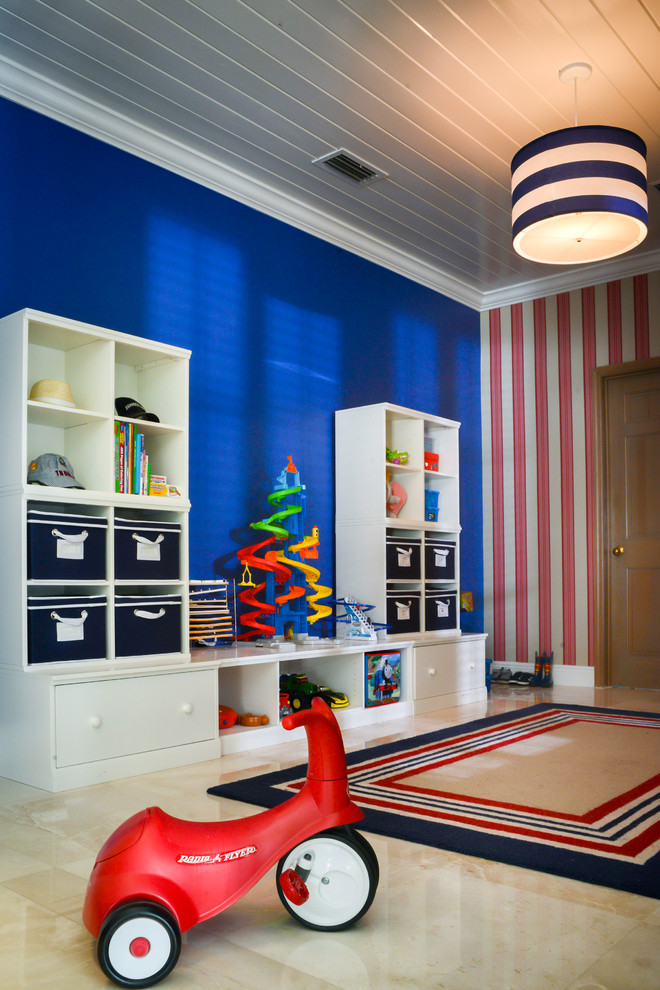 Photo of a large eclectic kids' playroom for kids 4-10 years old and boys in Miami with blue walls and marble floors.