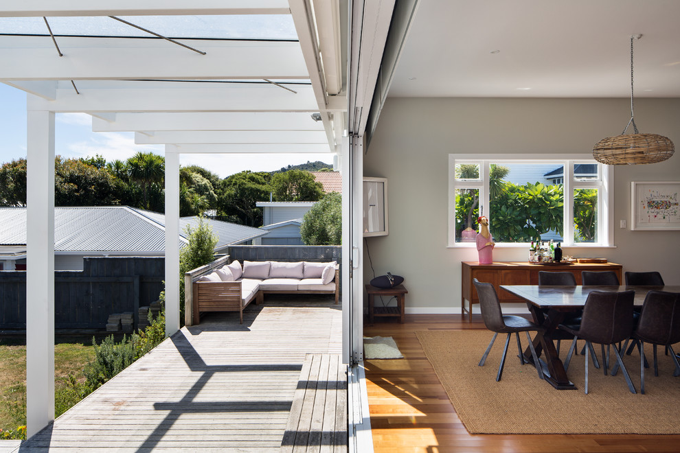 Design ideas for a contemporary backyard patio in Wellington with an outdoor kitchen, decking and a pergola.