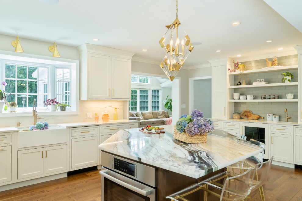 Large traditional kitchen in New York with shaker cabinets, marble worktops and an island.
