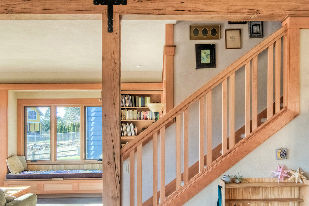 Photo of a mid-sized arts and crafts wood straight staircase in Seattle with wood railing.