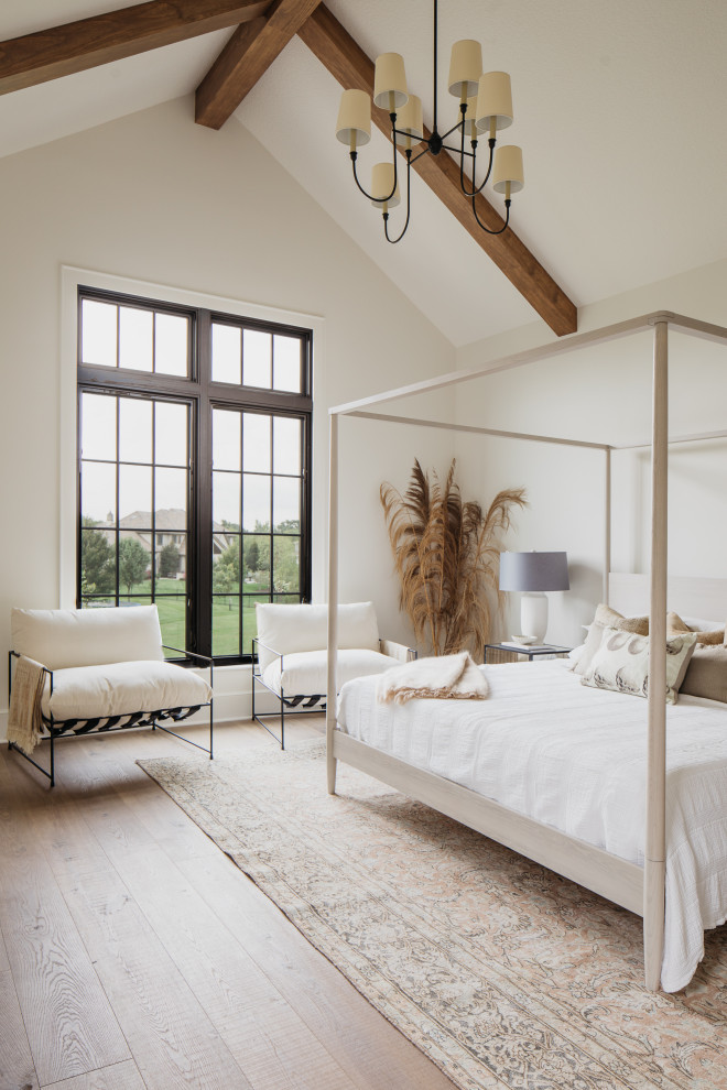 Inspiration for a country bedroom in Kansas City with white walls, light hardwood floors, beige floor, exposed beam and vaulted.