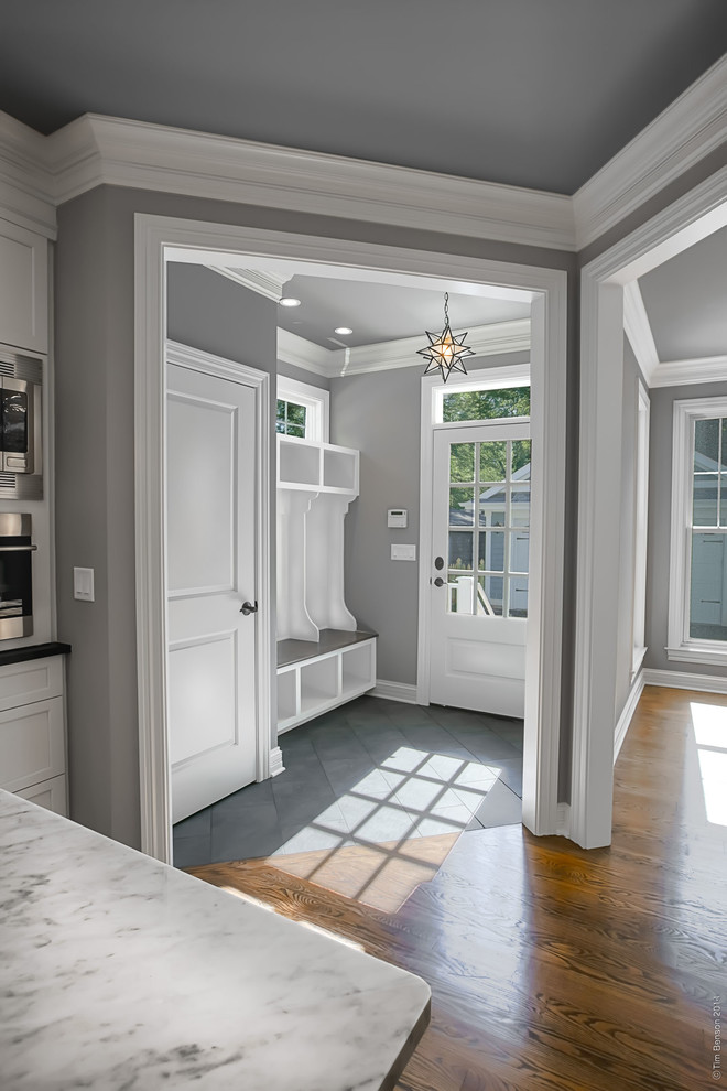 Mid-sized traditional mudroom in Chicago with grey floor, grey walls, slate floors, a single front door and a white front door.
