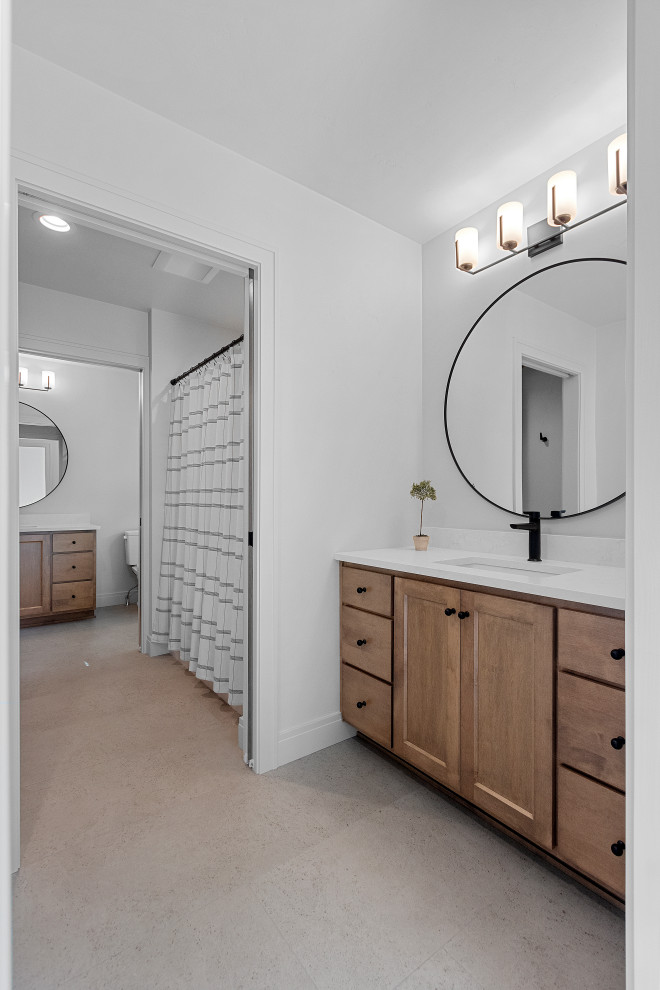 Inspiration for a large transitional kids' vinyl floor, multicolored floor and double-sink drop-in bathtub remodel with shaker cabinets, medium tone wood cabinets, a two-piece toilet, white walls, an undermount sink, quartz countertops, white countertops and a built-in vanity