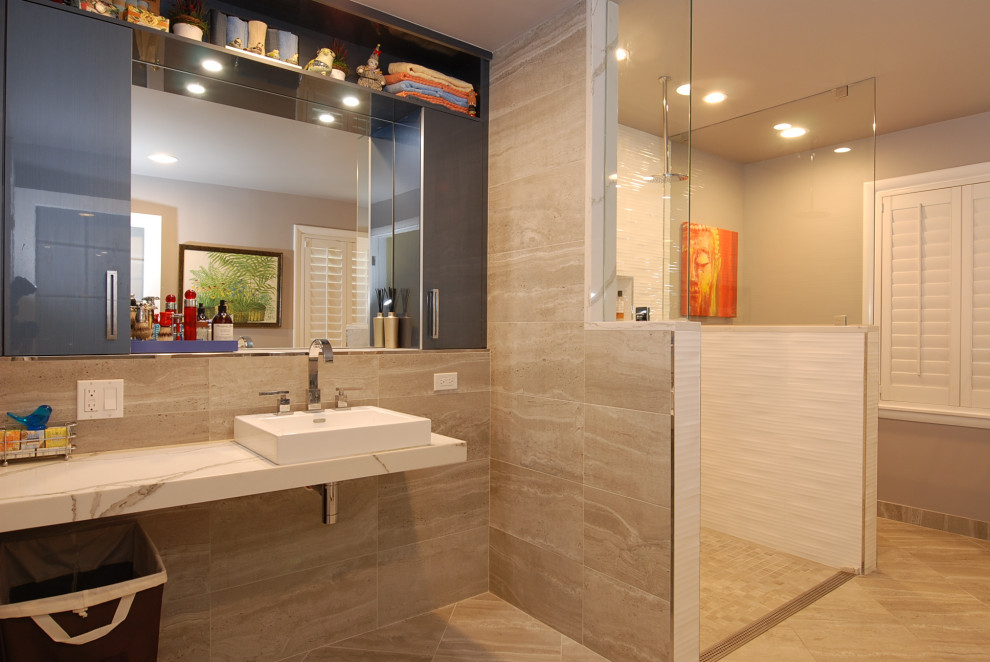 Photo of a large modern master bathroom in Chicago with flat-panel cabinets, blue cabinets, an alcove shower, a one-piece toilet, gray tile, porcelain tile, white walls, porcelain floors, a vessel sink, marble benchtops, beige floor, an open shower, white benchtops, a niche, a single vanity and a floating vanity.