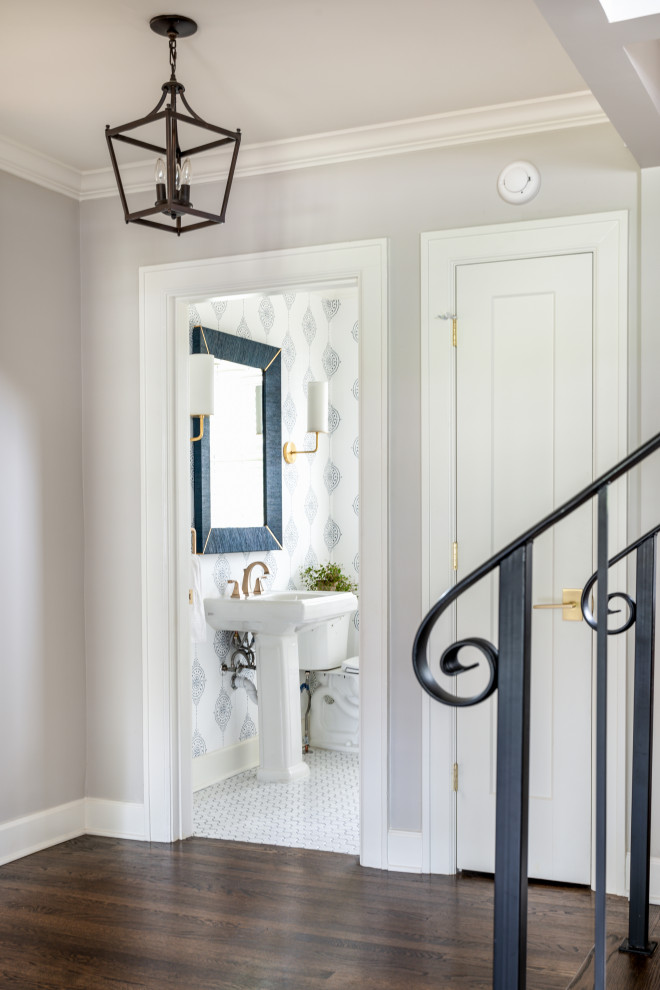 Small transitional powder room in Nashville with white cabinets, a two-piece toilet, white walls, mosaic tile floors, a pedestal sink, white floor and wallpaper.