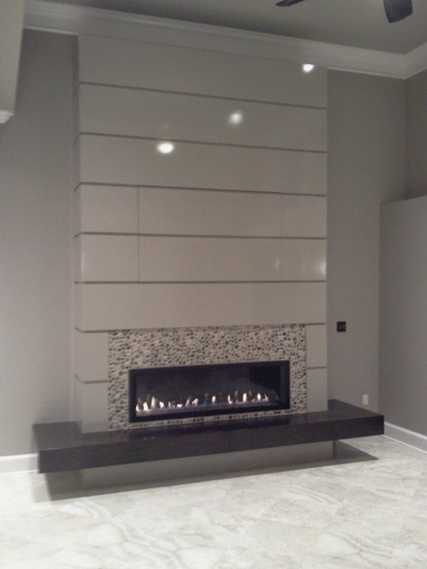 Example of a huge minimalist formal and open concept ceramic tile home design design in Little Rock with gray walls, a hanging fireplace, a stone fireplace and a media wall