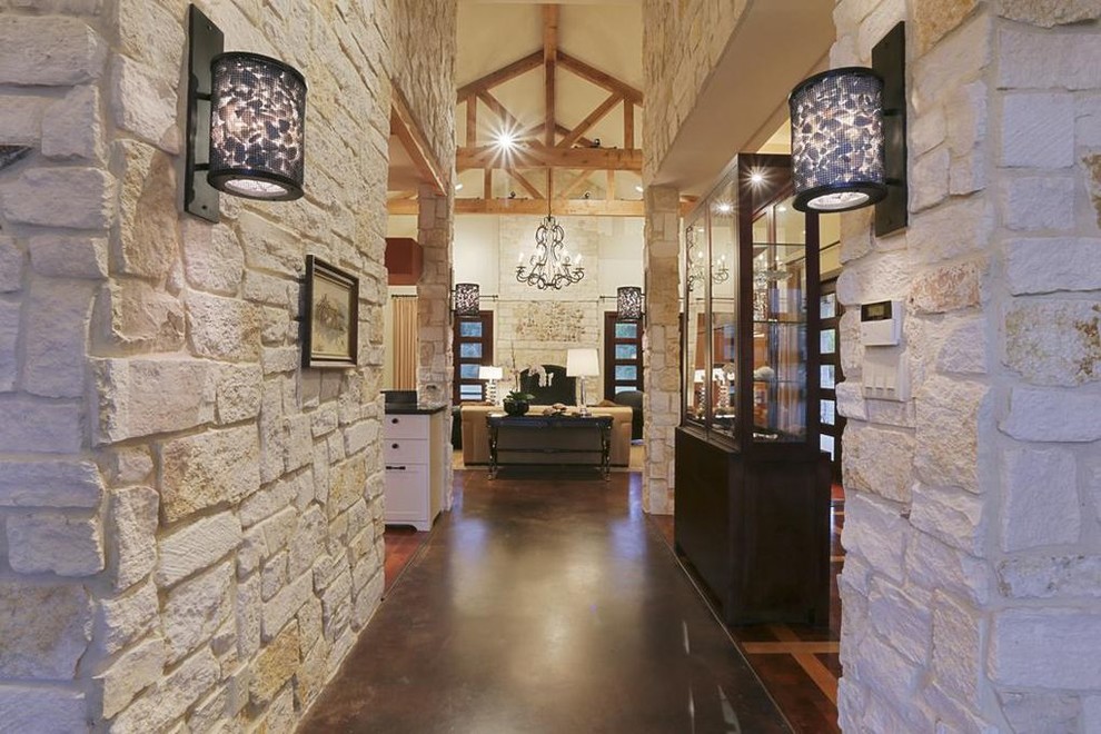 Inspiration for a mid-sized country foyer in Houston with white walls, concrete floors, a double front door, a dark wood front door and black floor.