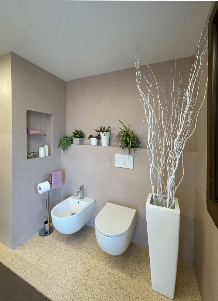 Photo of a mid-sized contemporary 3/4 bathroom in Other with flat-panel cabinets, white cabinets, a two-piece toilet, pink tile, pink walls, terrazzo floors, solid surface benchtops, pink floor, brown benchtops, a single vanity and a floating vanity.