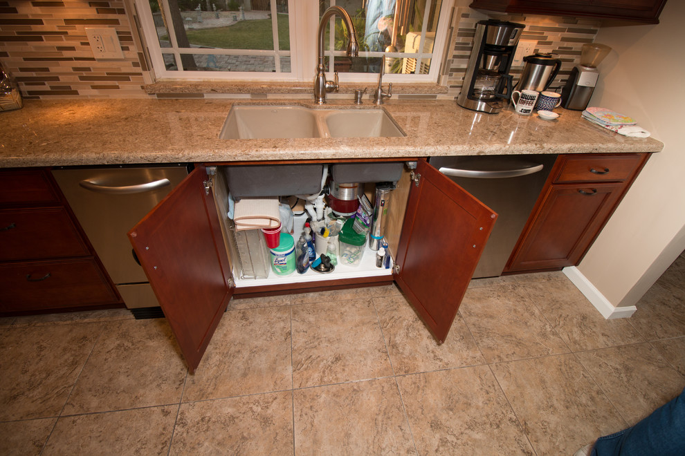 Kitchen - large transitional u-shaped porcelain tile kitchen idea with an undermount sink, flat-panel cabinets, medium tone wood cabinets, quartz countertops, beige backsplash, mosaic tile backsplash, stainless steel appliances and an island