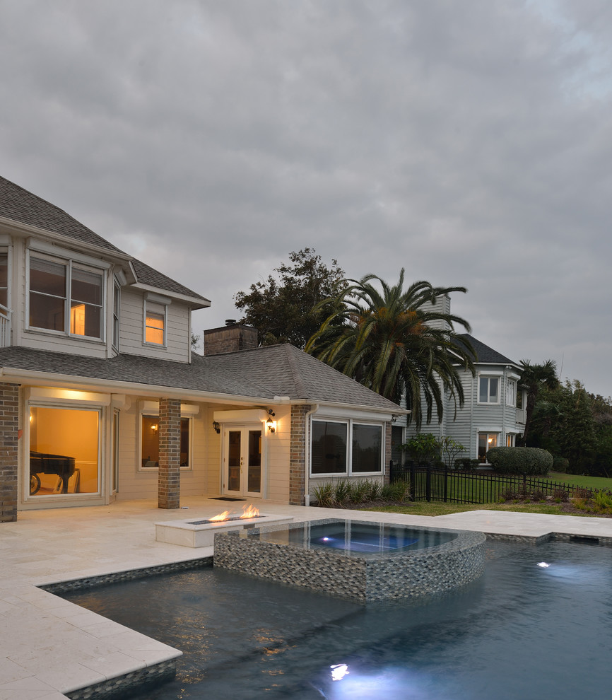 Hot tub - large transitional backyard stone and custom-shaped infinity hot tub idea in Houston