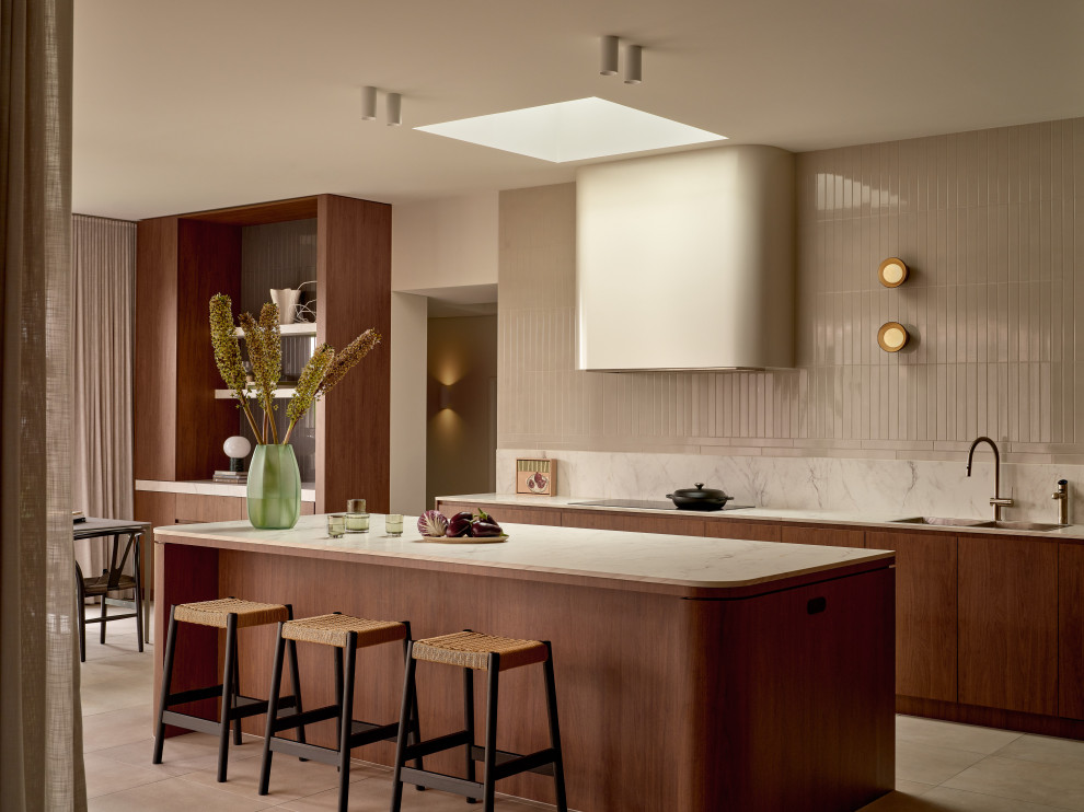 Photo of an expansive midcentury l-shaped open plan kitchen in Sydney with a double-bowl sink, flat-panel cabinets, medium wood cabinets, porcelain floors and with island.