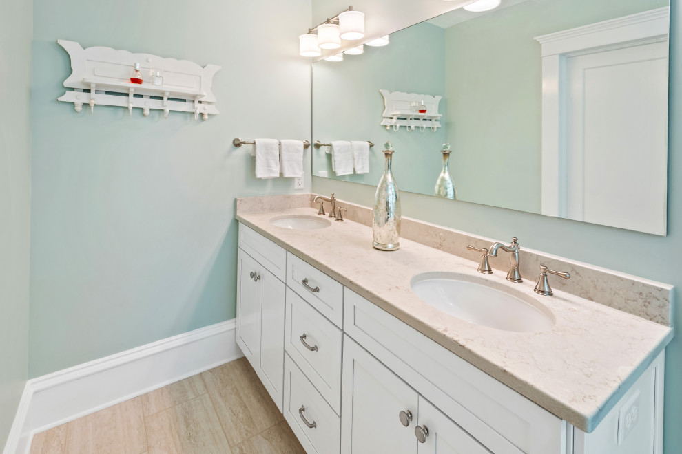 Design ideas for a mid-sized traditional kids bathroom in Raleigh with shaker cabinets, white cabinets, a two-piece toilet, white tile, porcelain tile, green walls, porcelain floors, an undermount sink, granite benchtops, beige floor, a hinged shower door and beige benchtops.