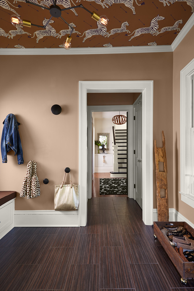 Inspiration for a transitional mudroom in Chicago with brown walls, ceramic floors and brown floor.