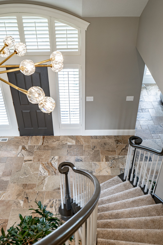 Inspiration for a transitional travertine floor and brown floor single front door remodel in Seattle with gray walls and a black front door