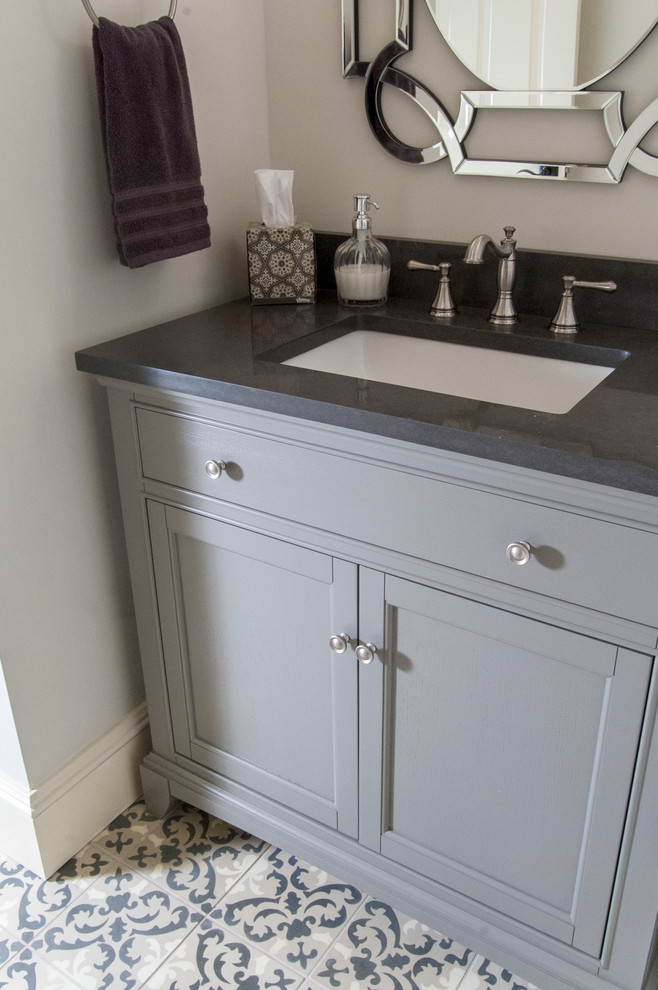 Mid-sized traditional powder room in Philadelphia with flat-panel cabinets, grey cabinets, a one-piece toilet, gray tile, grey walls, an undermount sink and engineered quartz benchtops.