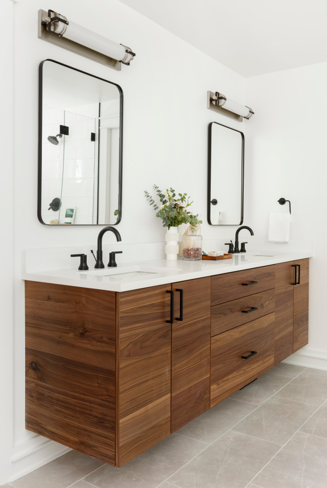 This is an example of a large country master bathroom in Portland with flat-panel cabinets, medium wood cabinets, a freestanding tub, a double shower, a two-piece toilet, white tile, ceramic tile, white walls, porcelain floors, an undermount sink, engineered quartz benchtops, grey floor, a hinged shower door, white benchtops, a shower seat, a double vanity and a floating vanity.