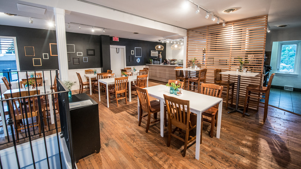 Example of a light wood floor dining room design in Calgary with gray walls