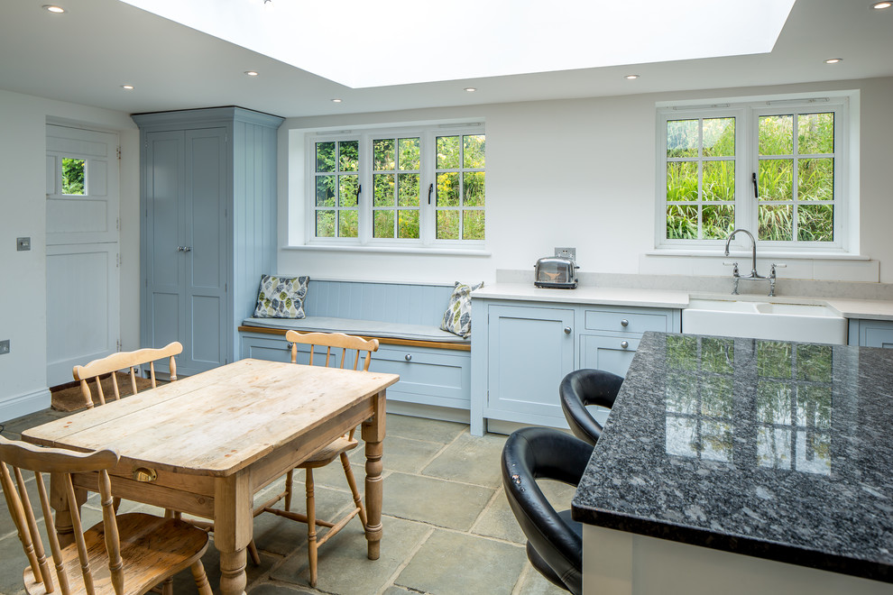 Photo of a large country l-shaped open plan kitchen in Hertfordshire with shaker cabinets, blue cabinets, granite benchtops and with island.