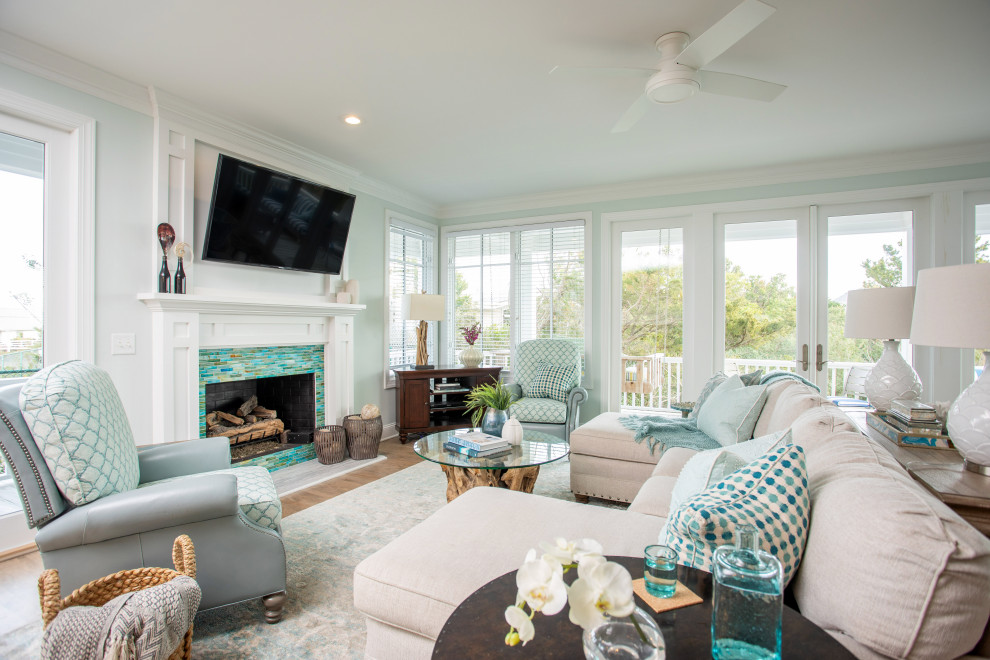 Photo of a large beach style open concept living room in Other with blue walls, a ribbon fireplace, a tile fireplace surround and a wall-mounted tv.