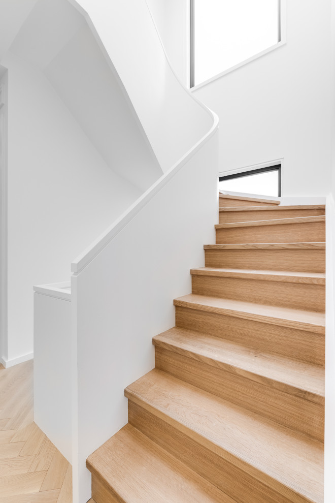 Inspiration for a medium sized traditional wood curved wood railing staircase in Toronto with wood risers.