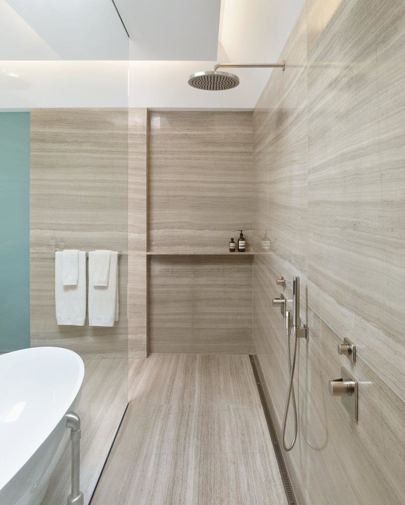 This is an example of a contemporary master bathroom in San Francisco with open cabinets, a freestanding tub, an open shower, beige walls, beige floor and an open shower.