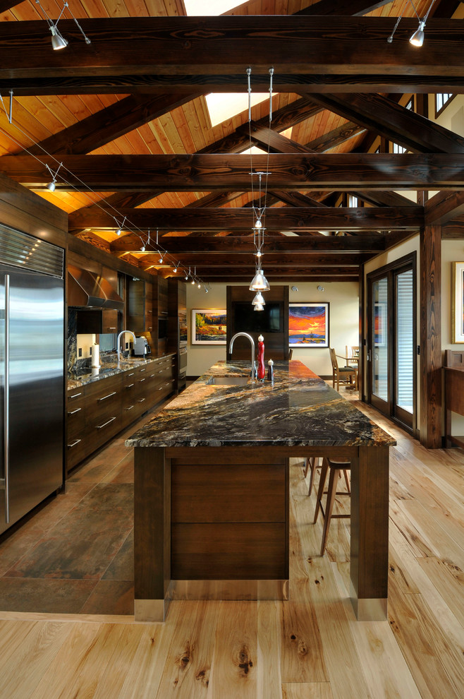Open concept kitchen - large rustic l-shaped light wood floor open concept kitchen idea in Vancouver with an undermount sink, flat-panel cabinets, dark wood cabinets, stainless steel appliances and an island