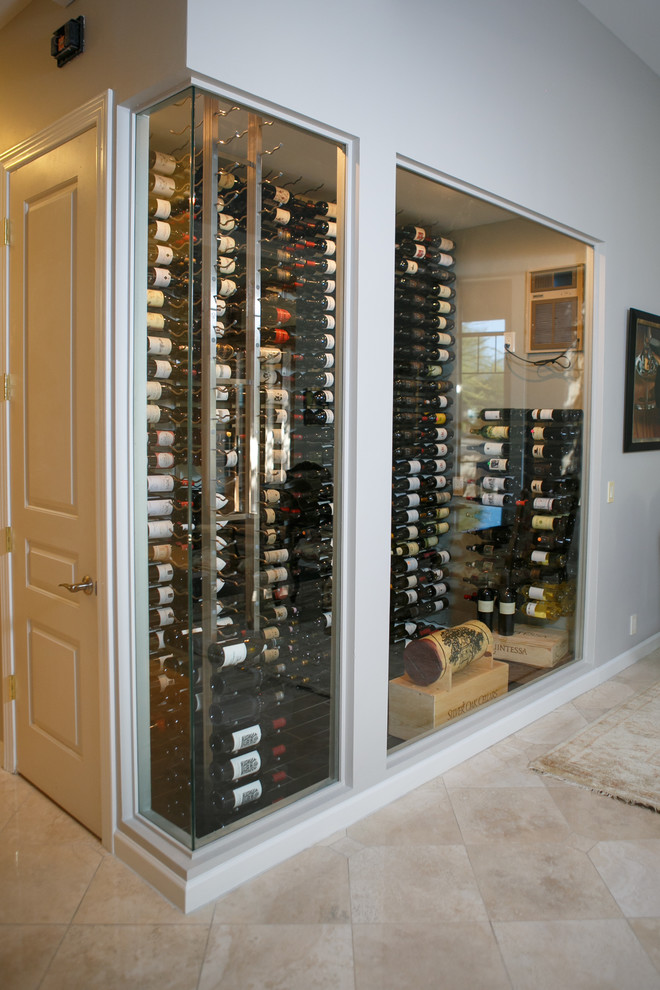 Photo of a mid-sized transitional wine cellar in Phoenix with storage racks, ceramic floors and brown floor.