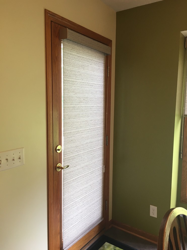 Inspiration for a transitional entryway remodel in Omaha with a white front door