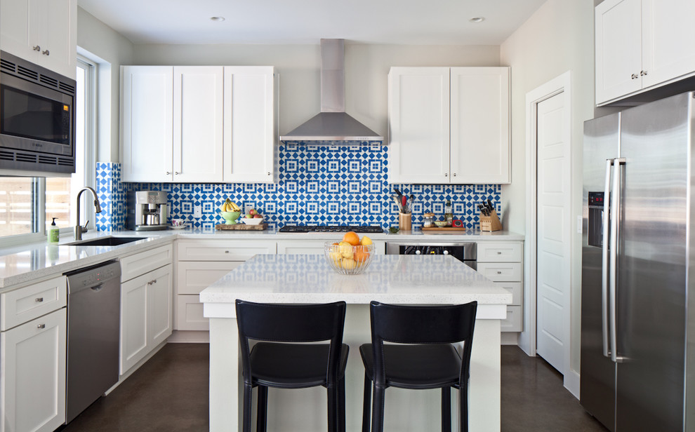 Transitional u-shaped kitchen photo in Austin with an undermount sink, shaker cabinets, white cabinets, multicolored backsplash, stainless steel appliances and an island
