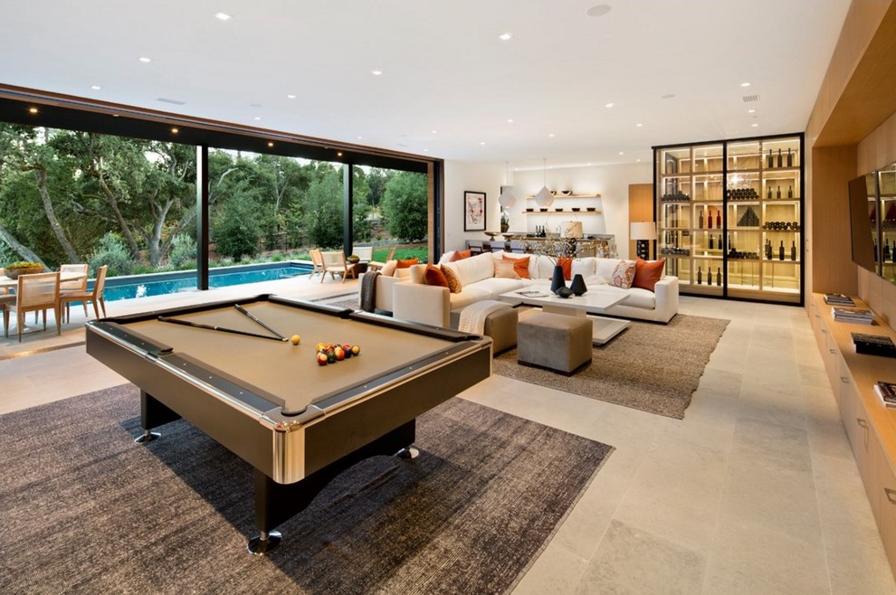 Large contemporary walk-out basement in San Francisco with a game room, white walls, grey floor and limestone floors.
