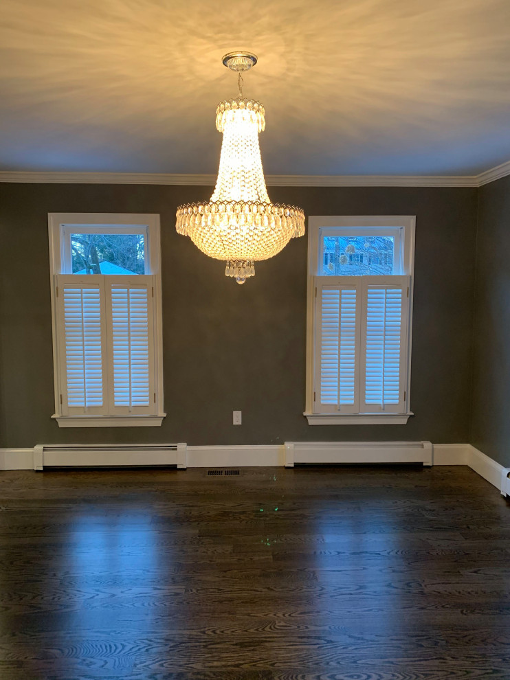Example of a mid-sized transitional dark wood floor and brown floor enclosed dining room design in Boston with gray walls