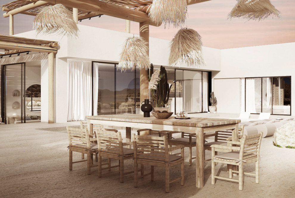 Réalisation d'une grande terrasse arrière méditerranéenne avec une cuisine d'été, des pavés en pierre naturelle et une pergola.