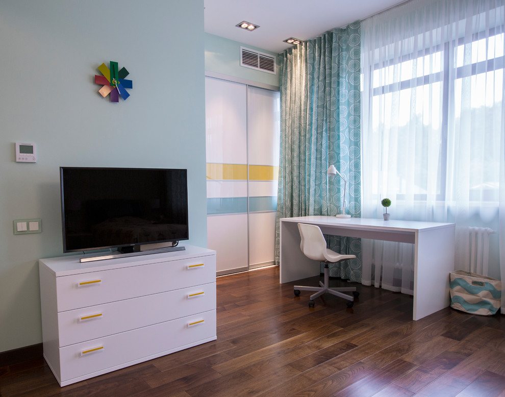 This is an example of a large contemporary kids' room for girls in Moscow with green walls, medium hardwood floors and brown floor.