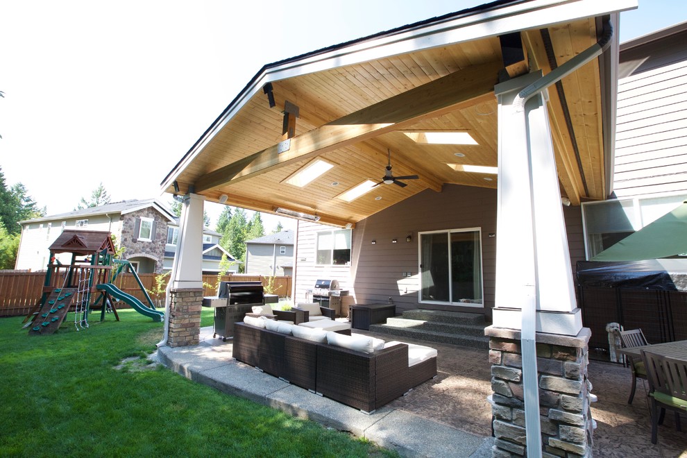 Mid-sized contemporary backyard patio in Seattle with concrete slab and a roof extension.