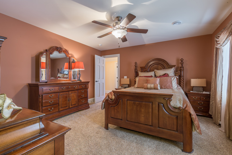 Example of a classic master carpeted and beige floor bedroom design in Cleveland with pink walls