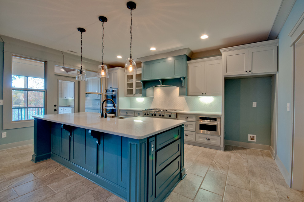 Example of a large transitional single-wall porcelain tile and multicolored floor open concept kitchen design with a farmhouse sink, shaker cabinets, gray cabinets, quartz countertops, white backsplash, ceramic backsplash, stainless steel appliances, an island and white countertops
