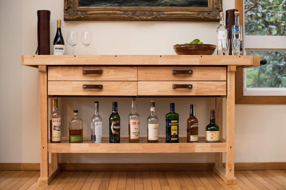 Photo of a mid-sized industrial single-wall bar cart in Portland with light wood cabinets, wood benchtops, white splashback and beige benchtop.