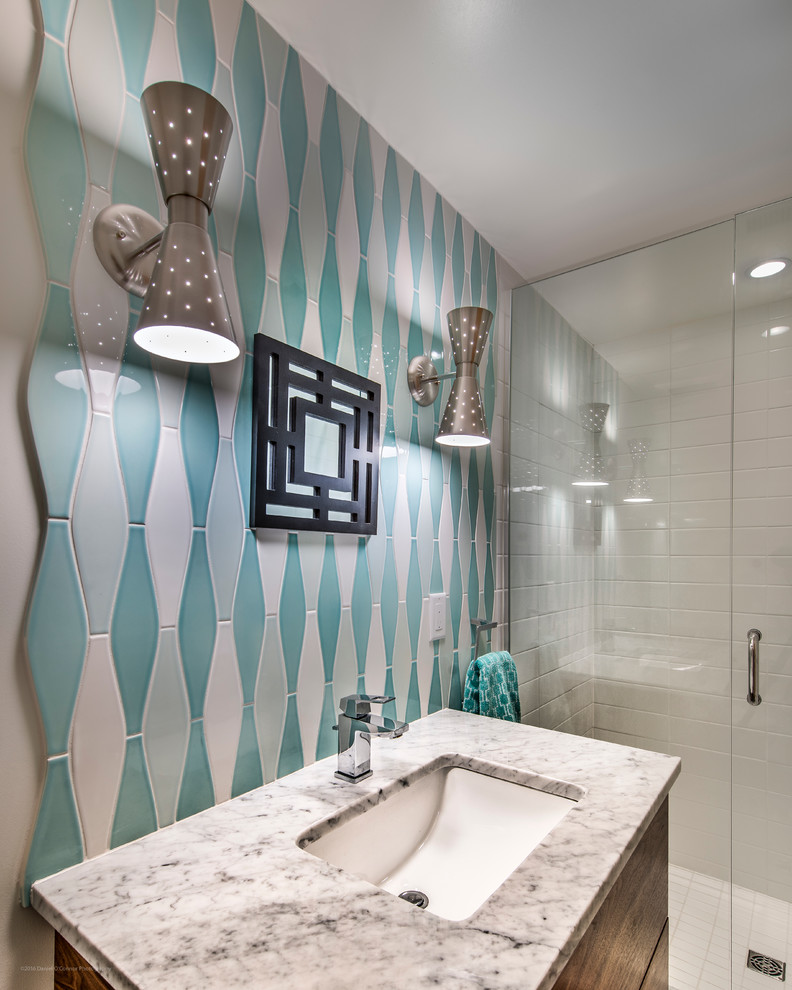 This is an example of a mid-sized midcentury 3/4 bathroom in Denver with flat-panel cabinets, dark wood cabinets, an alcove shower, blue tile, white tile, ceramic tile, white walls, an undermount sink and marble benchtops.