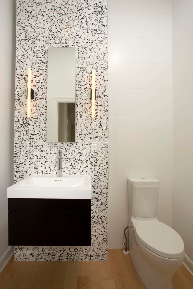 Design ideas for a modern powder room in DC Metro with light hardwood floors.