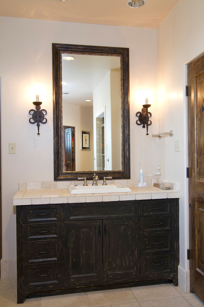 Design ideas for a large arts and crafts bathroom in Dallas with shaker cabinets, distressed cabinets, tile benchtops, an undermount tub, beige tile, beige walls and ceramic floors.