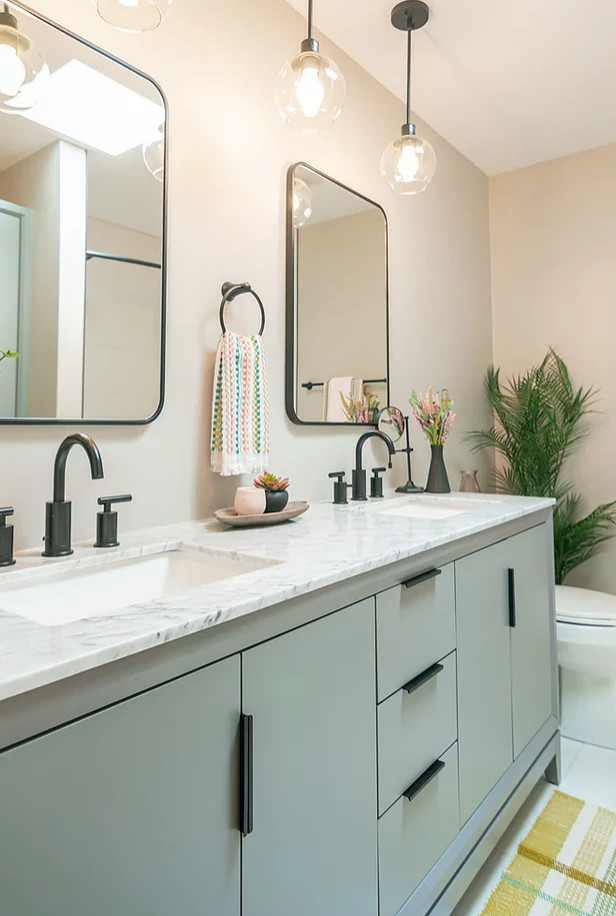 Photo of a small scandinavian master bathroom in Minneapolis with flat-panel cabinets, grey cabinets, an alcove tub, a shower/bathtub combo, a one-piece toilet, white tile, ceramic tile, grey walls, ceramic floors, an undermount sink, engineered quartz benchtops, white floor, a shower curtain, white benchtops, a double vanity and a freestanding vanity.