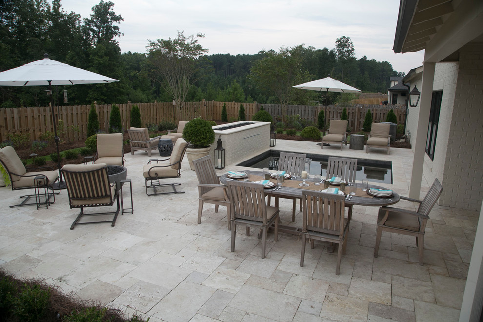 Design ideas for a small backyard patio in Birmingham with natural stone pavers.