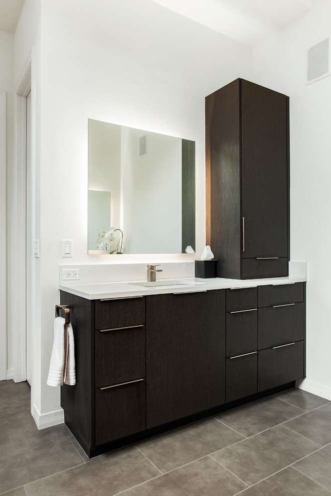 Large transitional master bathroom in Dallas with flat-panel cabinets, brown cabinets, a curbless shower, a two-piece toilet, gray tile, marble, white walls, porcelain floors, an undermount sink, engineered quartz benchtops, beige floor, an open shower and white benchtops.