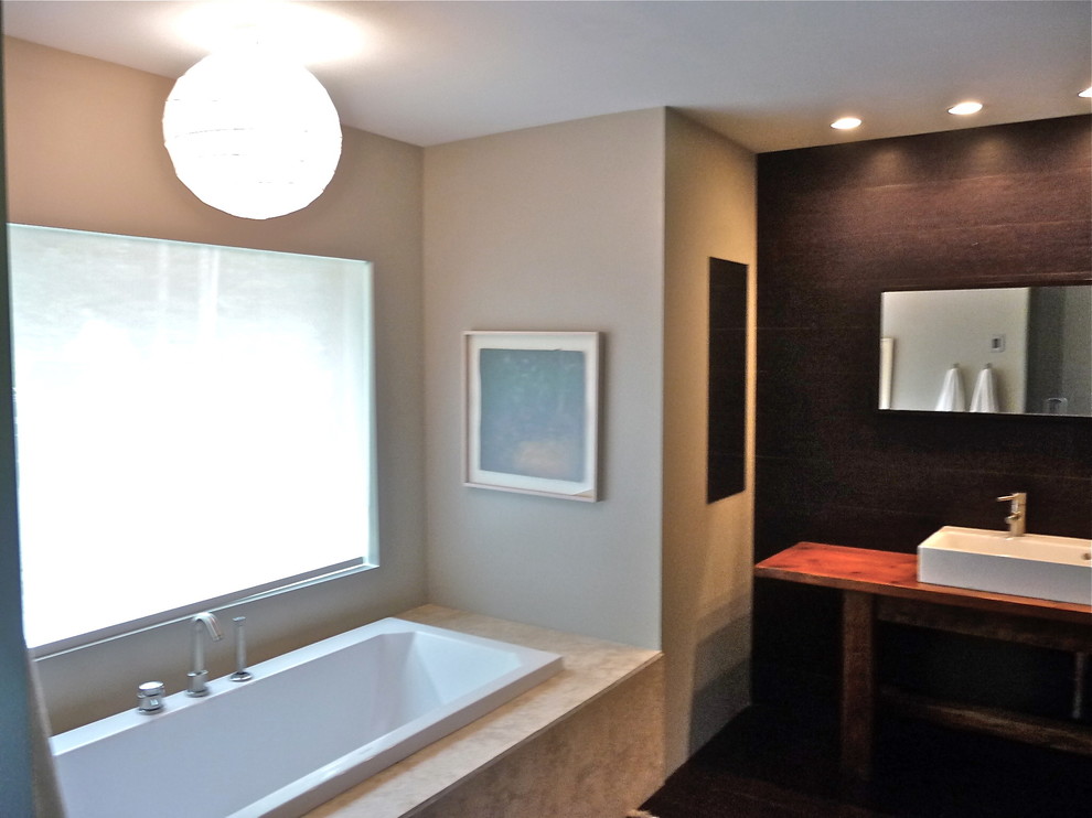 Mid-sized contemporary master bathroom in New York with a drop-in tub, a double shower, a two-piece toilet, brown walls, cork floors, a vessel sink, wood benchtops, brown floor and a hinged shower door.