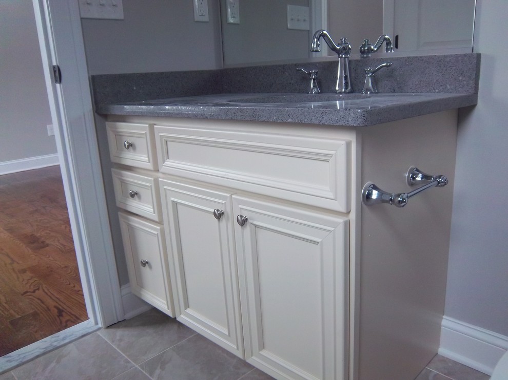 Bathroom - mid-sized transitional 3/4 gray floor bathroom idea with recessed-panel cabinets, beige cabinets, gray walls, an undermount sink and gray countertops