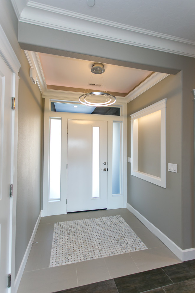 Example of a small transitional porcelain tile and gray floor front door design in Seattle with gray walls and a white front door